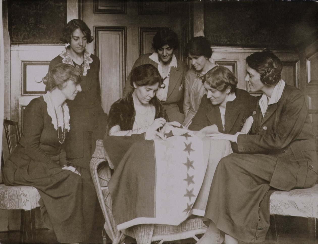 Alice Paul Sewing Stars on the Suffrage Flag as Other Women Look On by American Photographer