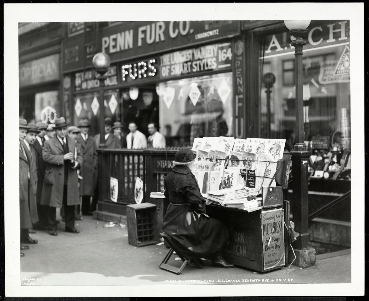 Blind news dealer, Aaron Weintraub, at his stand at the south east corner of 7th Avenue and 32nd Street, New York, 1926 by Byron Company