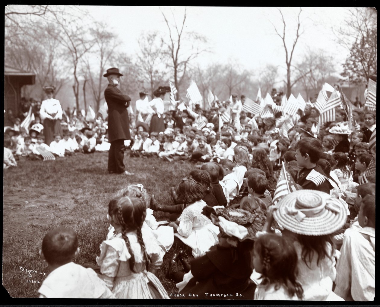 Children watching an entertainer on Arbor Day at Tompkins Square Park, New York, 1904 by Byron Company