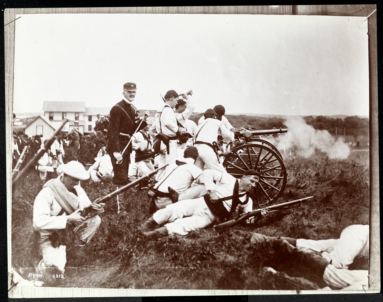 Copyphotograph of an earlier photo of soldiers from the New York Naval Reserves involved in a mock battle with guns and cannon, Fishers Island, New York, 1917 by Byron Company