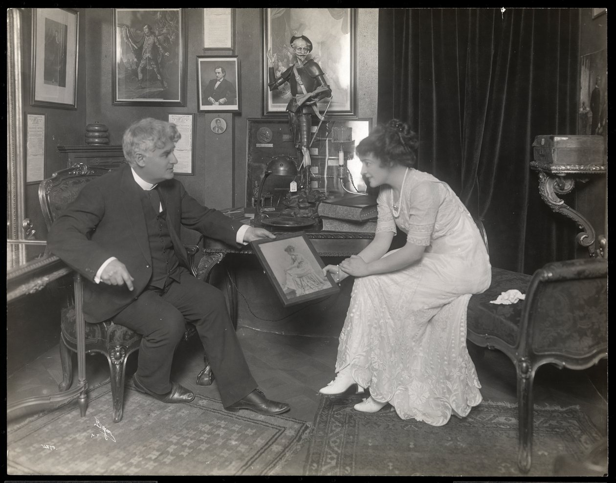 David Belasco showing a portrait to Frances Starr by Byron Company
