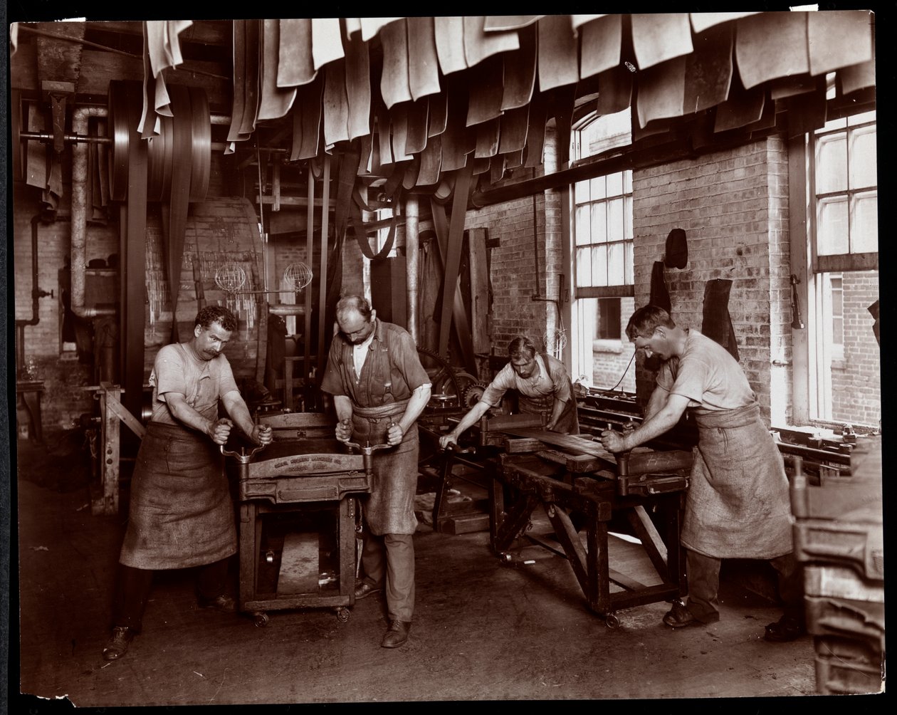 Interior view of men working on leather at the New York Leather Belting Co., New York, 1905-06 by Byron Company