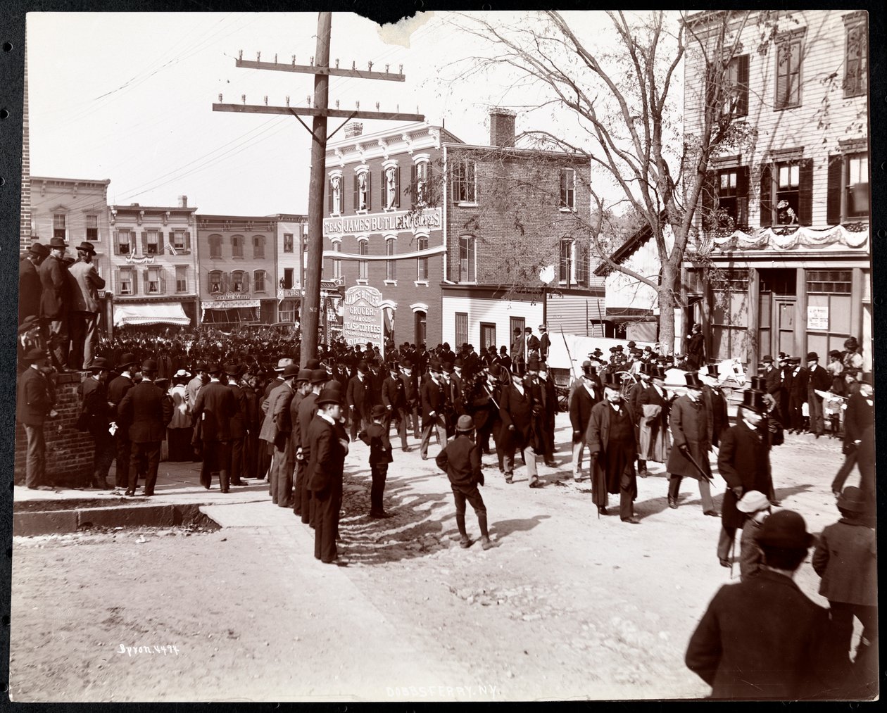 Military Parade with Uniformed Men in Top Hats in Dobbs Ferry, New York (1898) by Byron Company