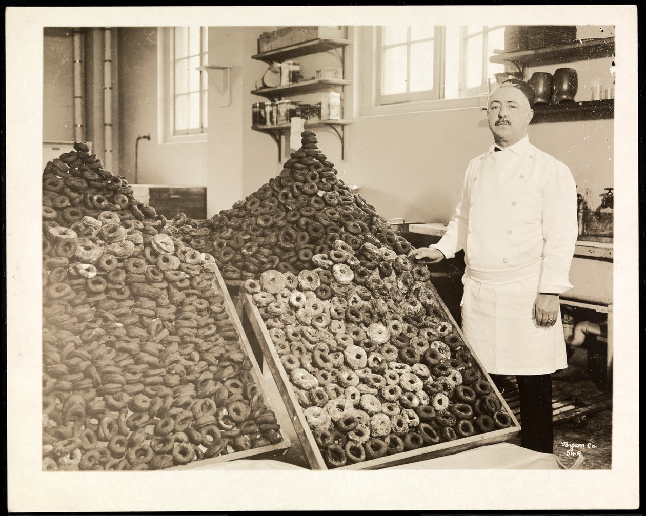 Portrait of Chef Leoni with Bins of Doughnuts for the Salvation Army at the Hotel Commodore by Byron Company