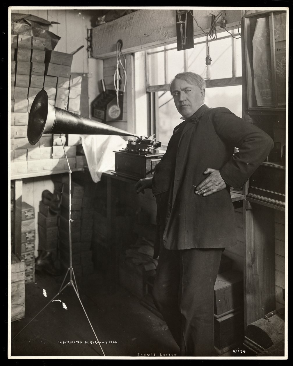 Thomas Edison Standing Next to a Phonograph in His Laboratory, 1920 by Byron Company