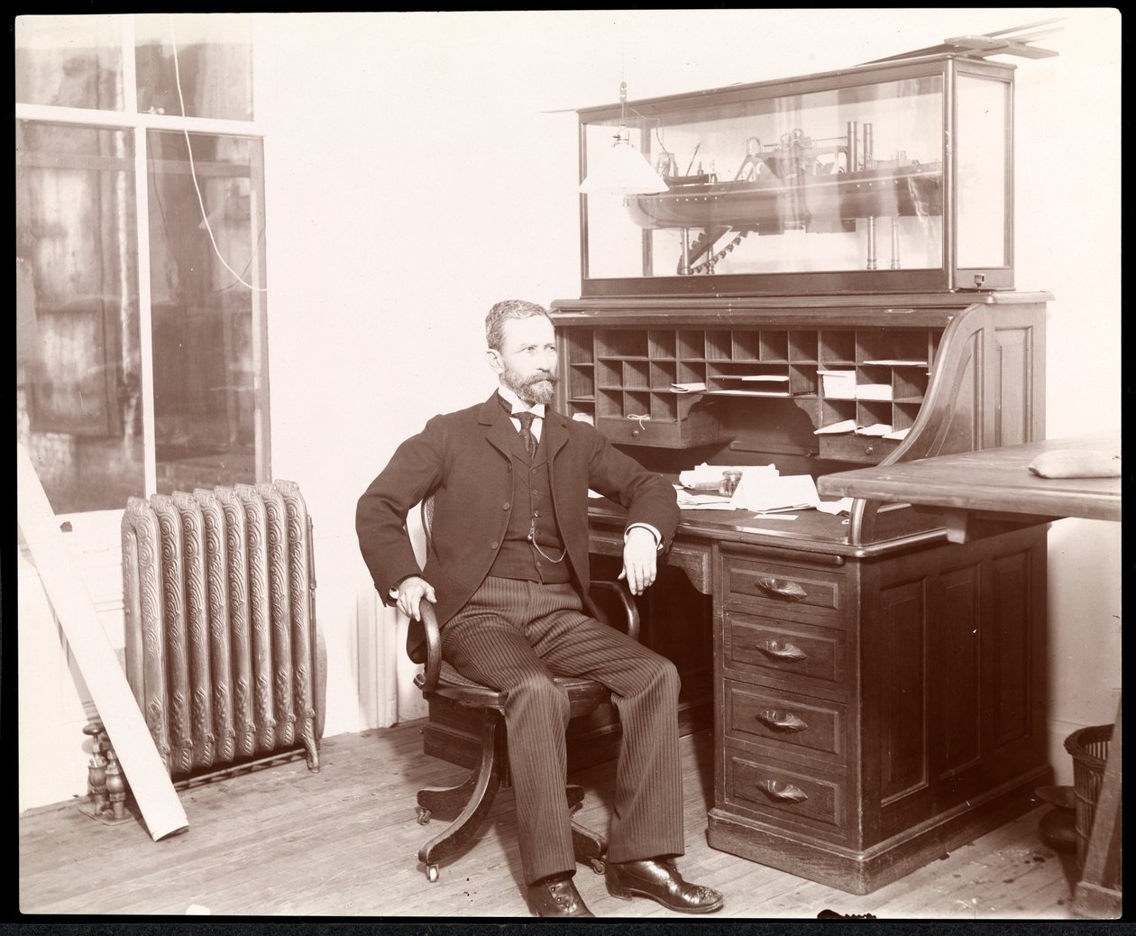 View of a man at a desk, presumably part of the Nicaragua Canal Commission, Nicaragua by Byron Company