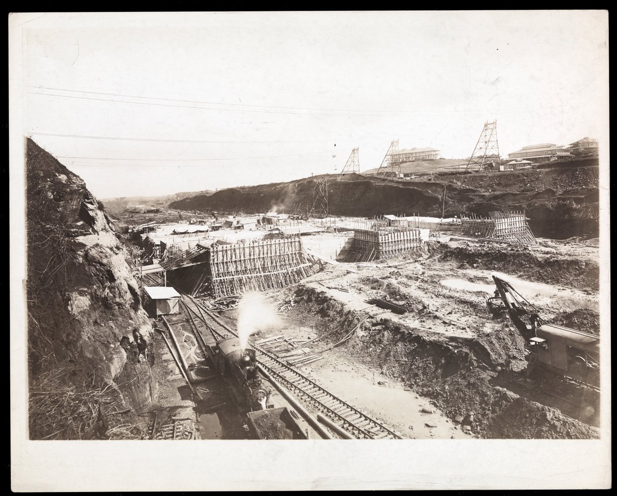 View of construction of the Panama Canal with concrete forms, trains, digging machines and excavations visible, 1912 or 1913 by Byron Company