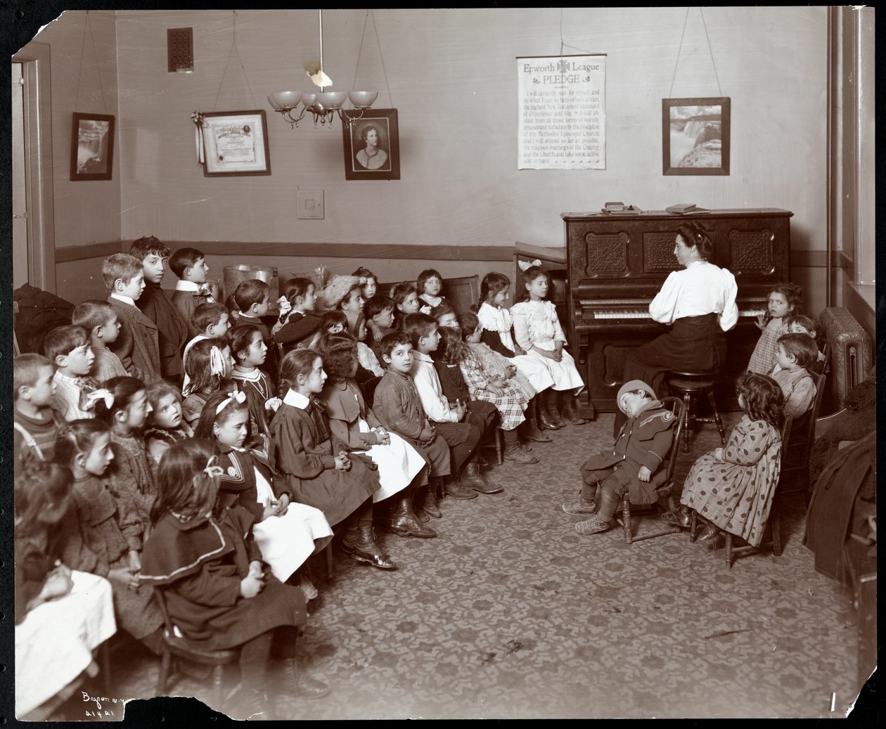 Women and children in a room with flowers at the National Fruit and Flower Guild, 247 Spring Street, New York, 1906 by Byron Company