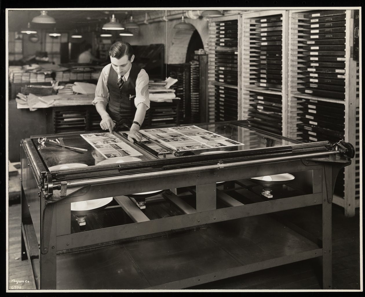 Working on a layout at a light table at Unz und Co., 24 Beaver Street, New York by Byron Company