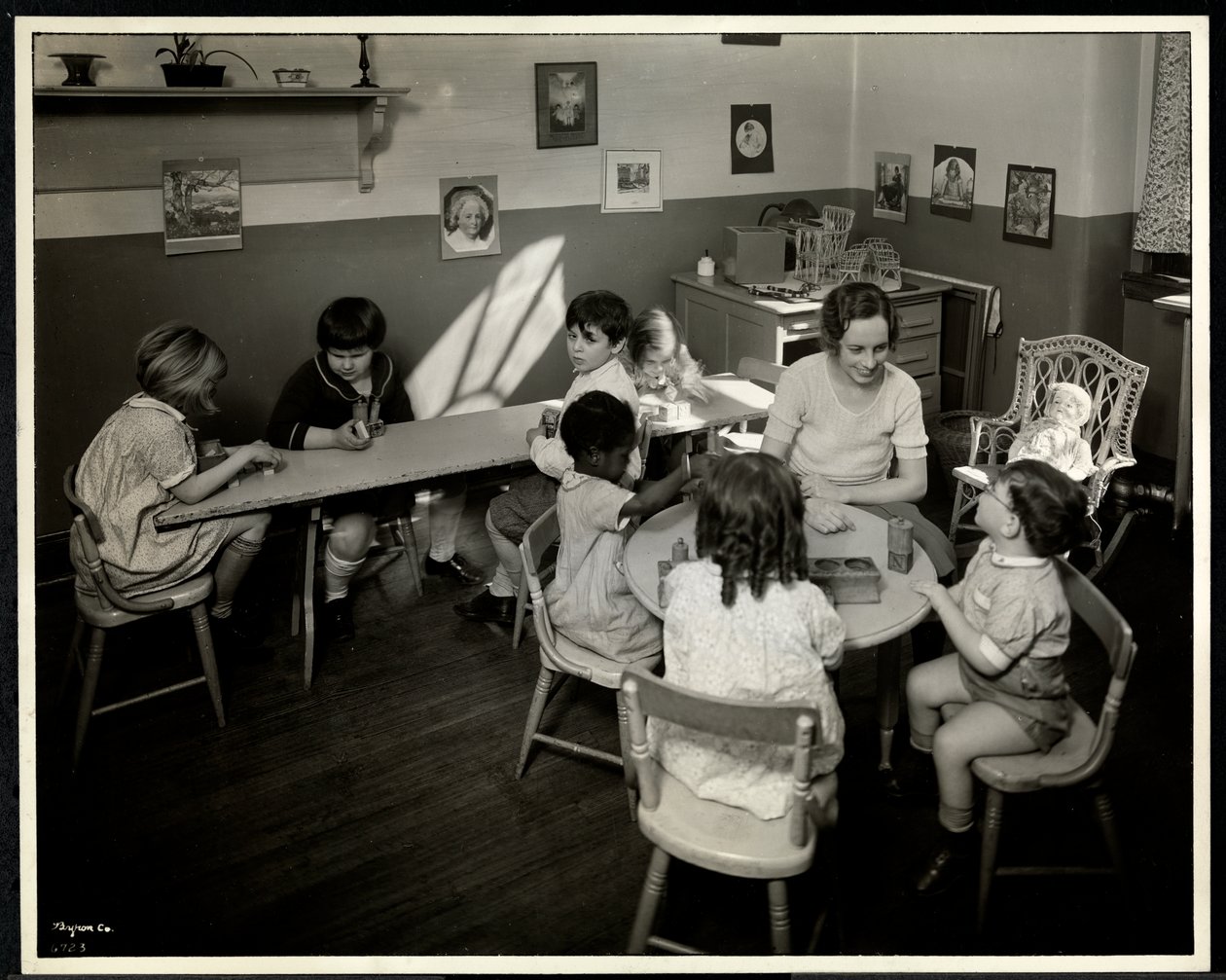 Young Blind Visually Impaired Children with a Female Teacher in the Nursery at the New York Association for the Blind, 111 East 59th Street, New York by Byron Company