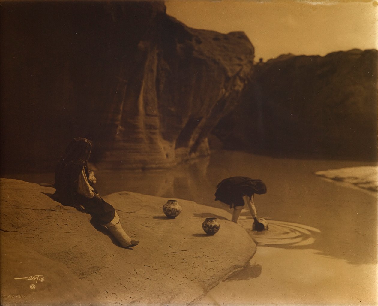 At the Old Well of Acoma by Edward S. Curtis