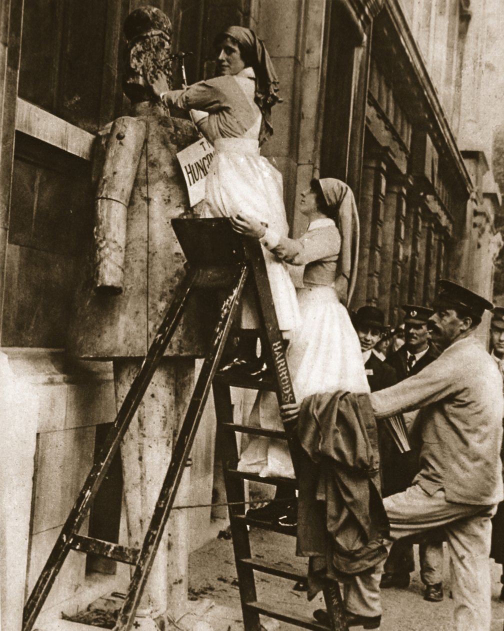 A hospital nurse reversing her usual role: hammering the enemy at Stepney by English Photographer