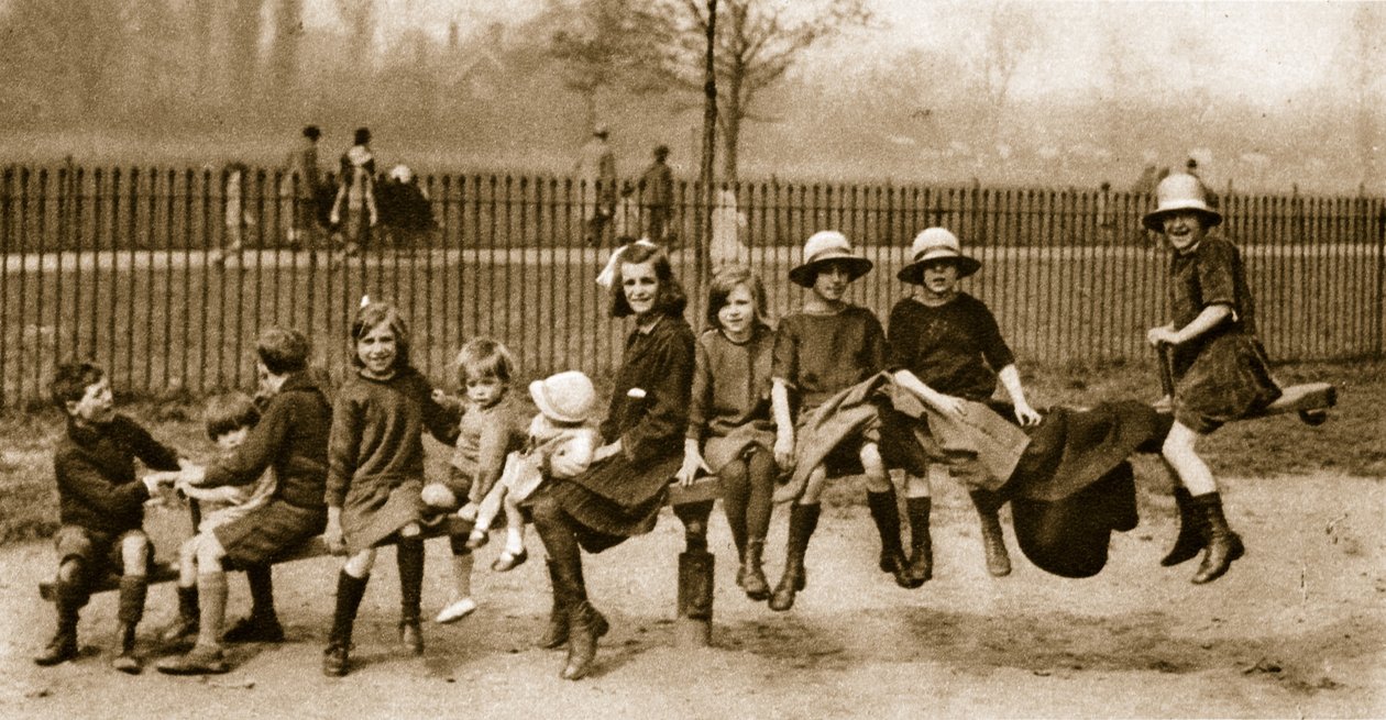 Children play on a see-saw in a London park by English Photographer