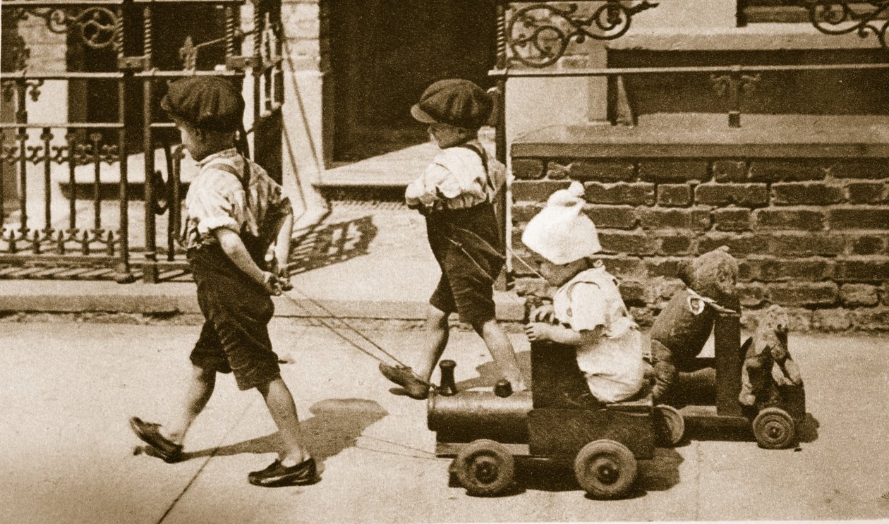 Children play on the street: boys pulling carts by English Photographer