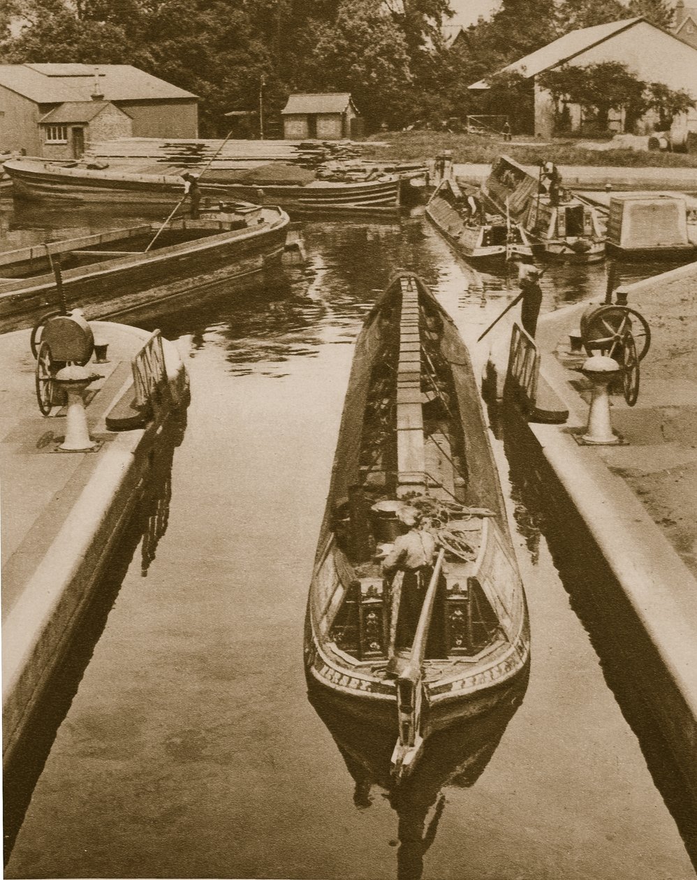 Pushing a monkey boat through a lock at Brentford by English Photographer