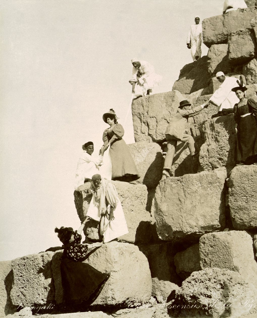 Tourists ascending the pyramids with native guides by English Photographer