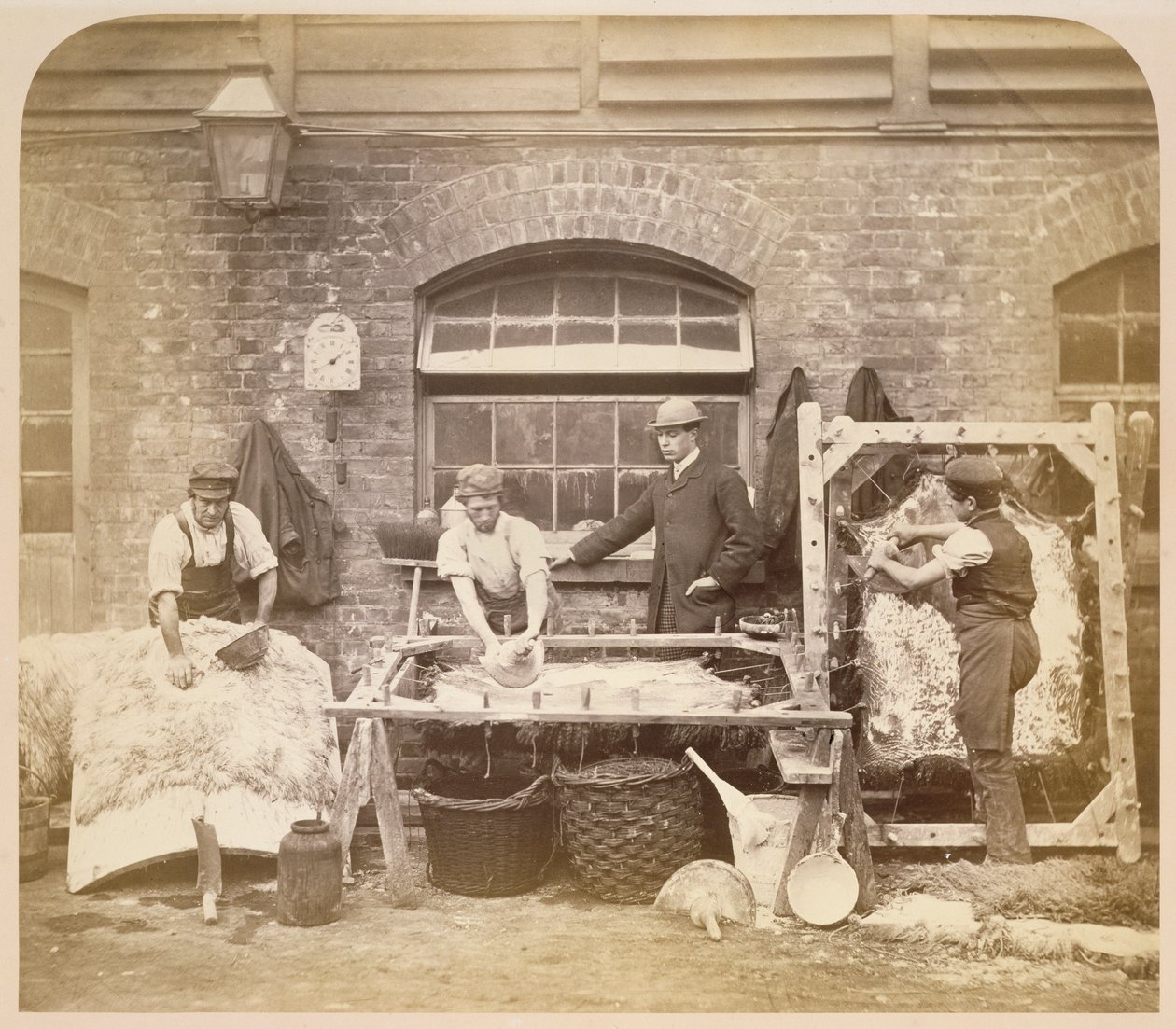 Workers making sheepskin rugs by English Photographer