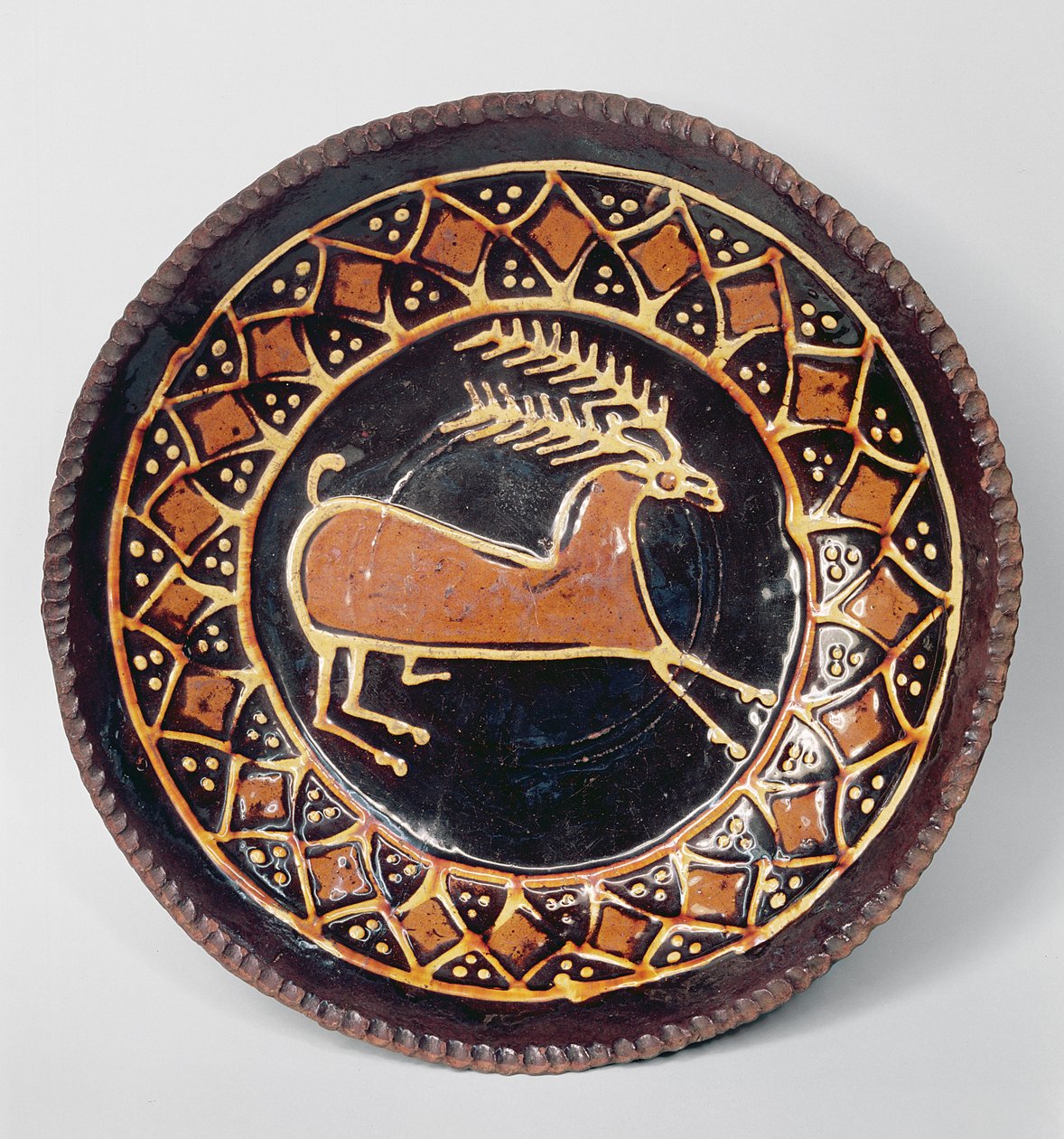 Staffordshire slipware dish decorated with a stag by English School