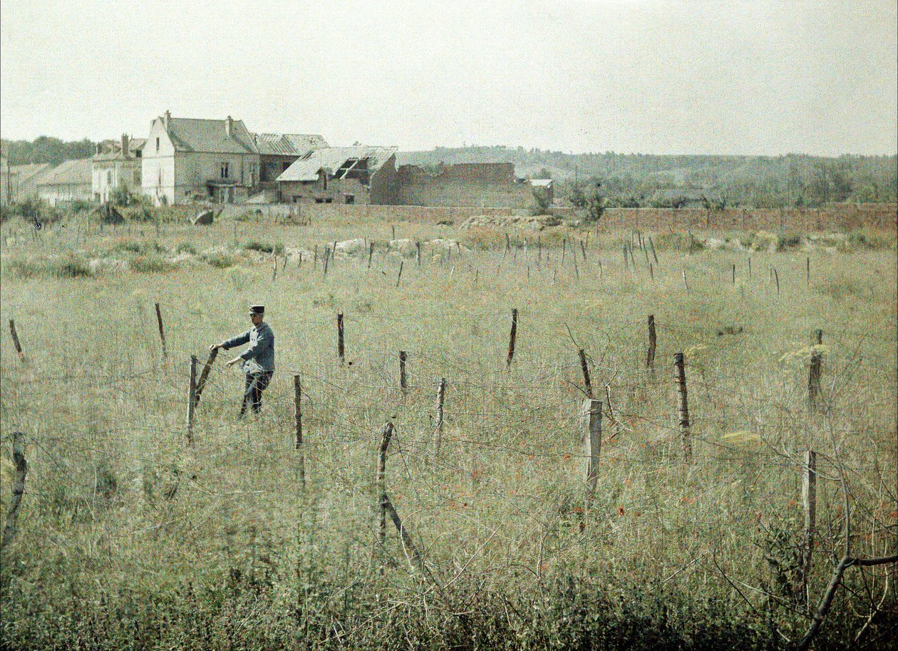 A French officer inspects the barbed wire around French positions, Soissons, Aisne, France, 1917 by Fernand Cuville