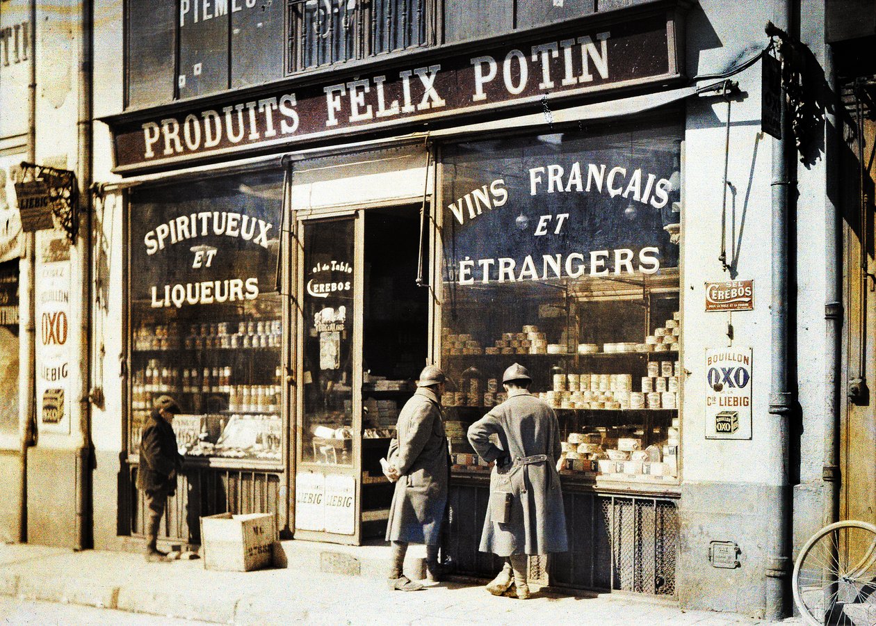Two French Soldiers and a Boy in Front of the Liquor Store Felix Potin at the Market, Reims, Marne, France by Fernand Cuville