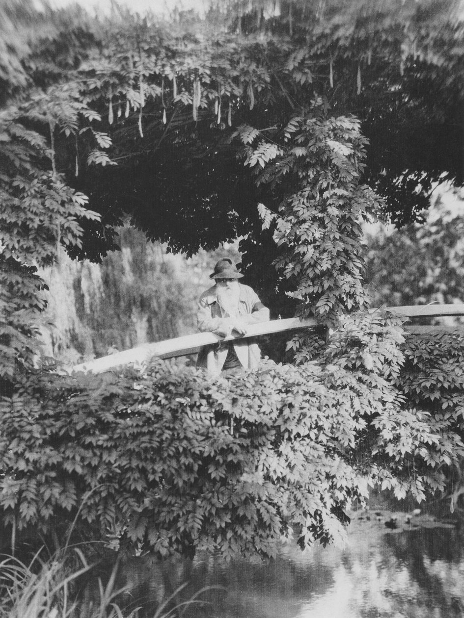 Claude Monet on the Japanese Bridge in his garden at Giverny by French Photographer