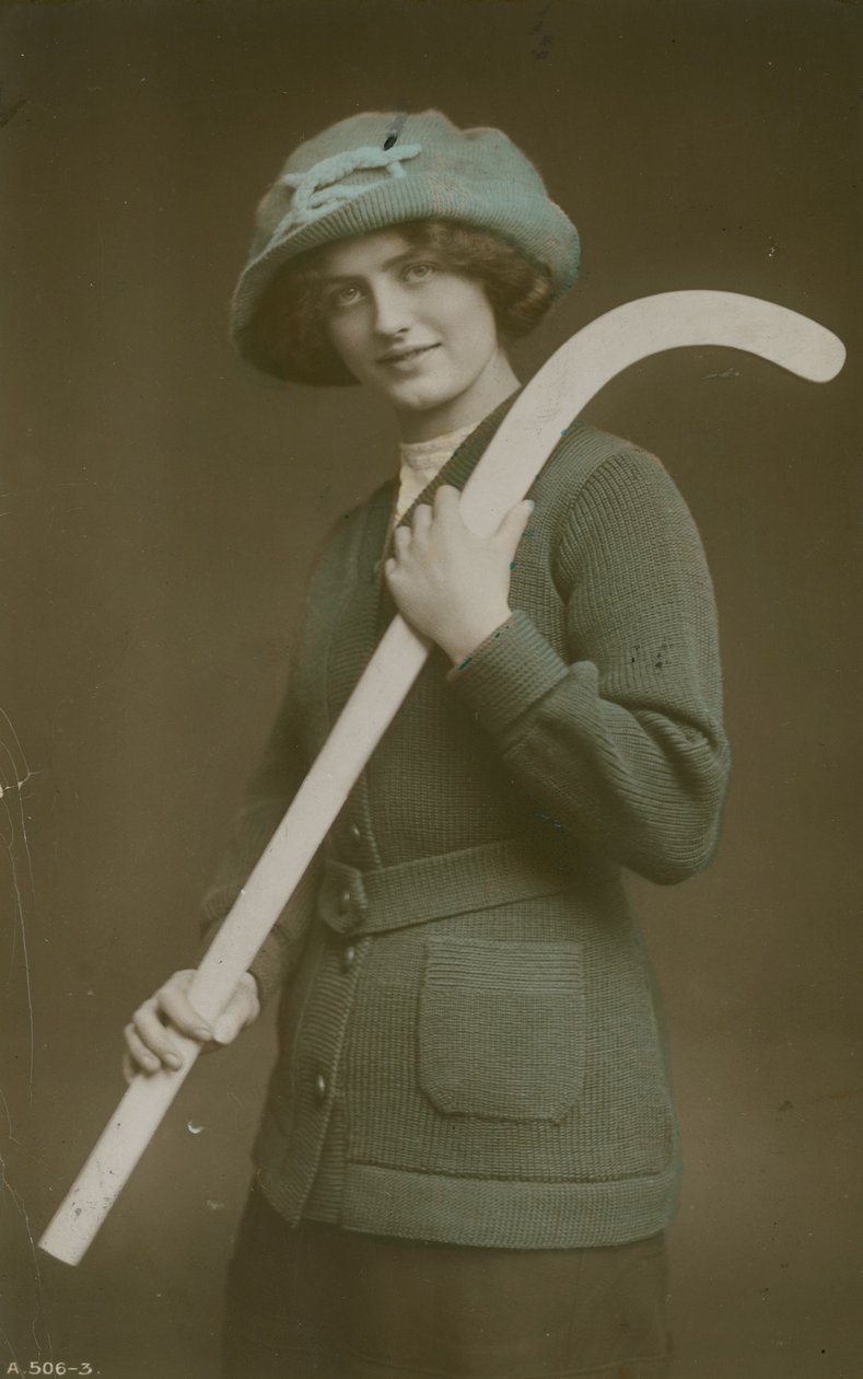 Young woman carrying a hockey stick over her shoulder by French Photographer