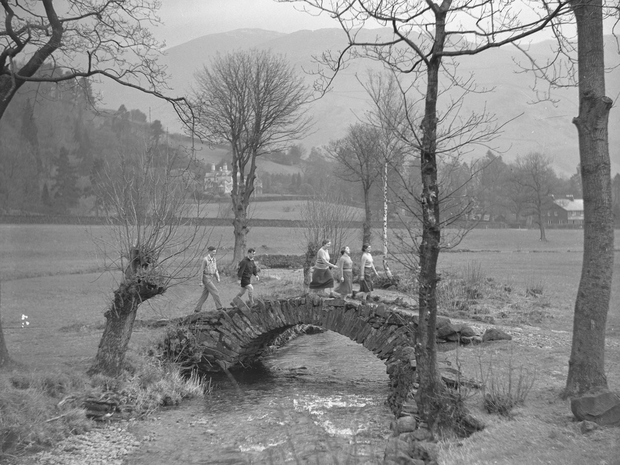 Group of young walkers walking over bridge by Joseph Hardman