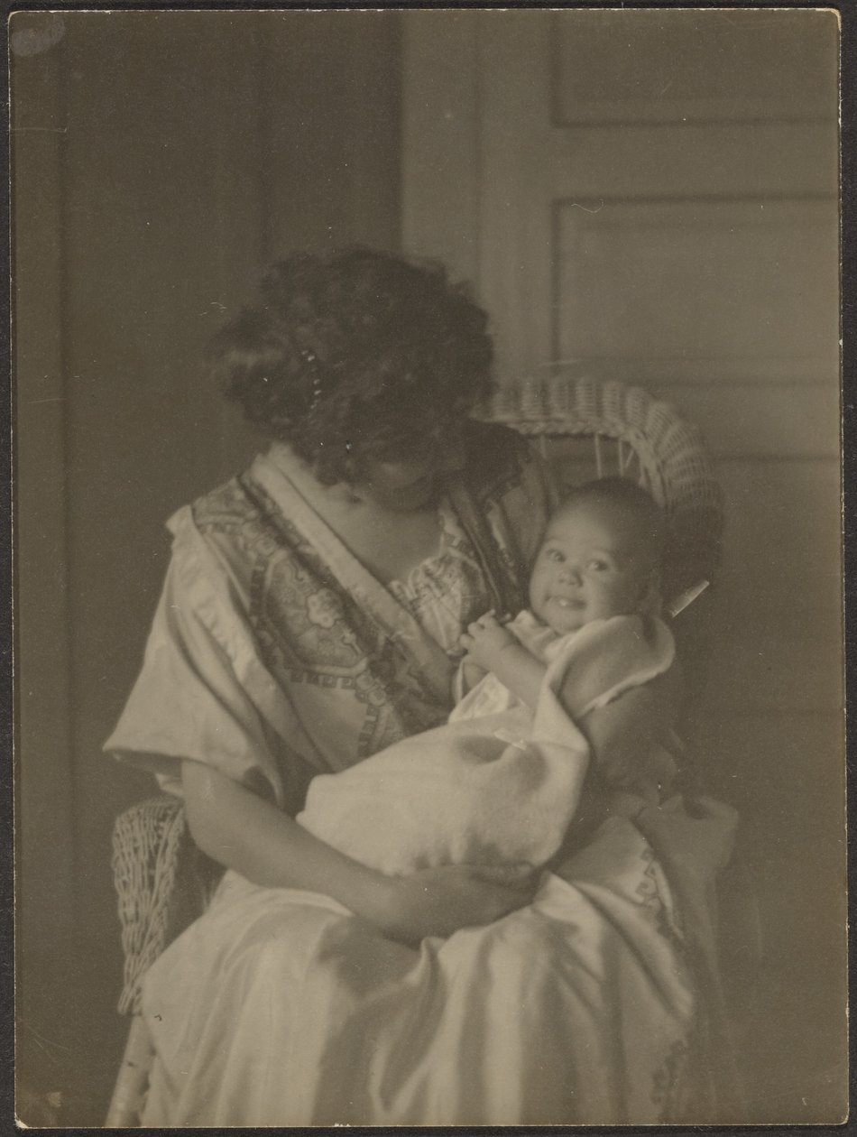 Florence Holding Baby in Rocking Chair by Louis Fleckenstein