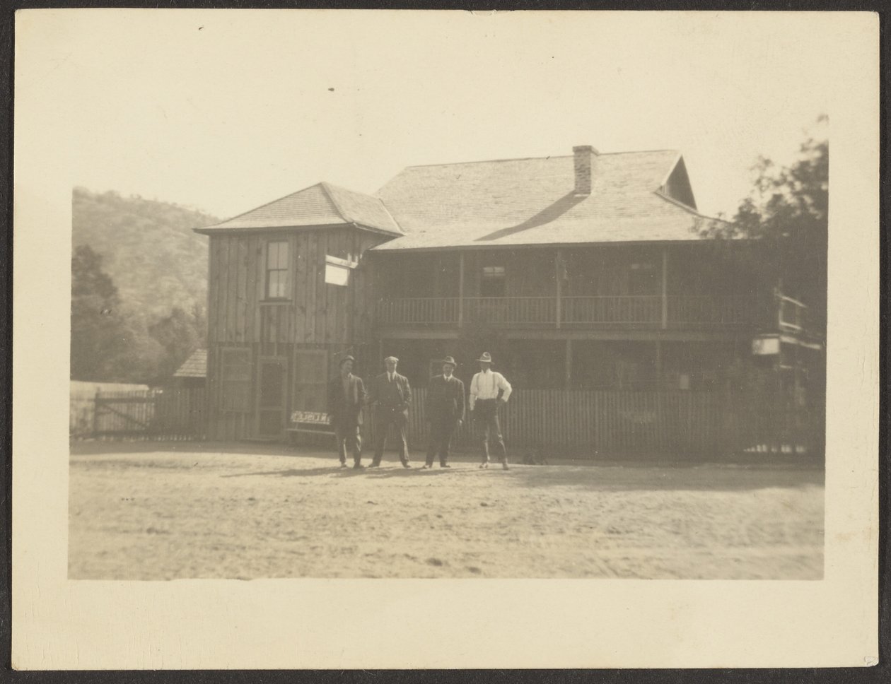 Four Men before Wooden Building by Louis Fleckenstein