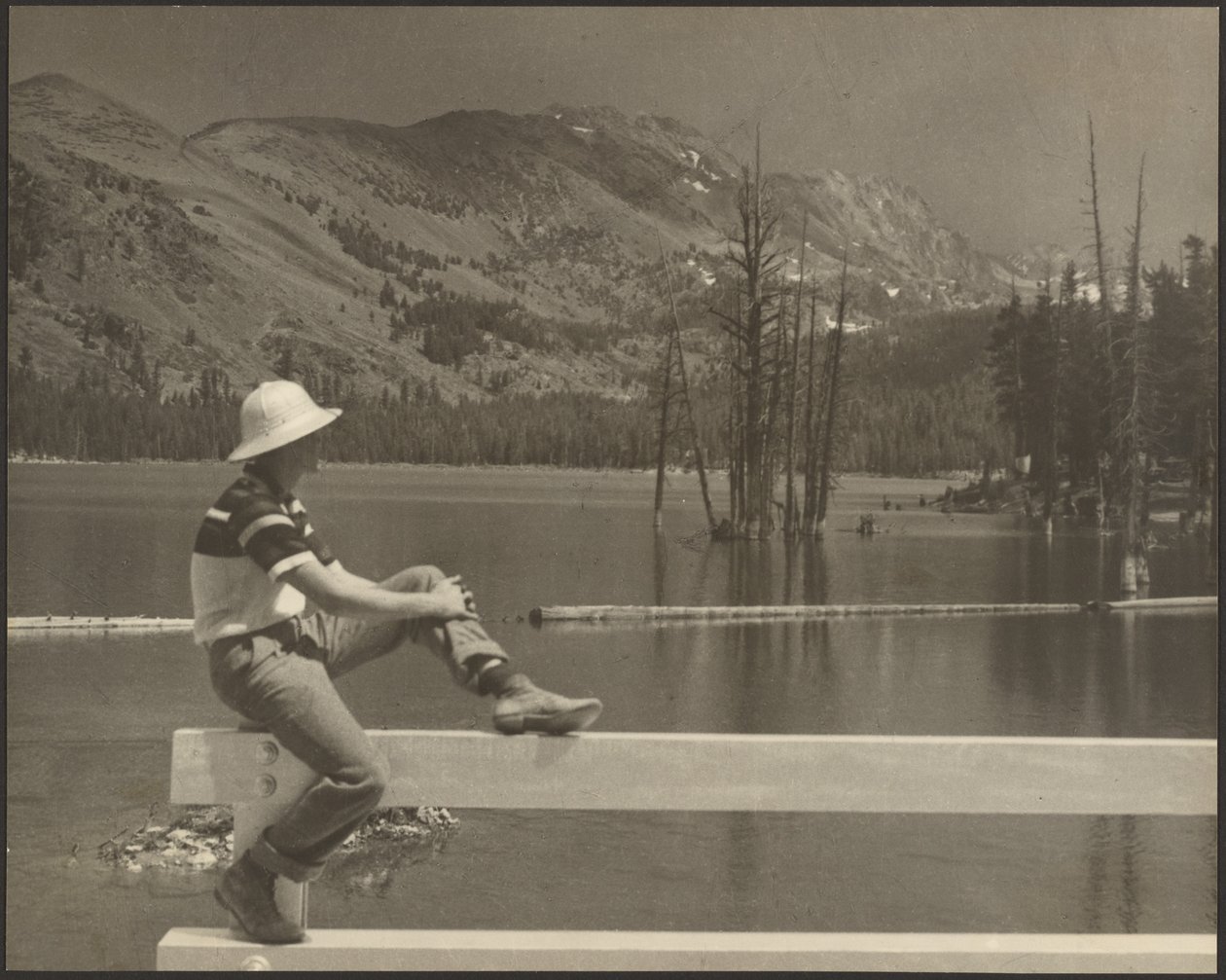 Man Sitting on Bench at Lake Side by Louis Fleckenstein