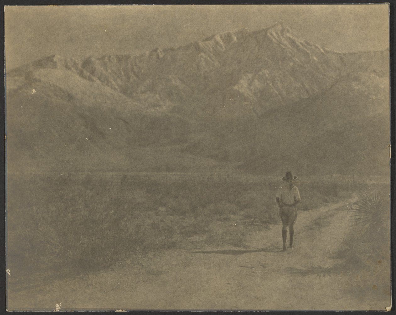Woman Walking on Path Towards Mountains by Louis Fleckenstein