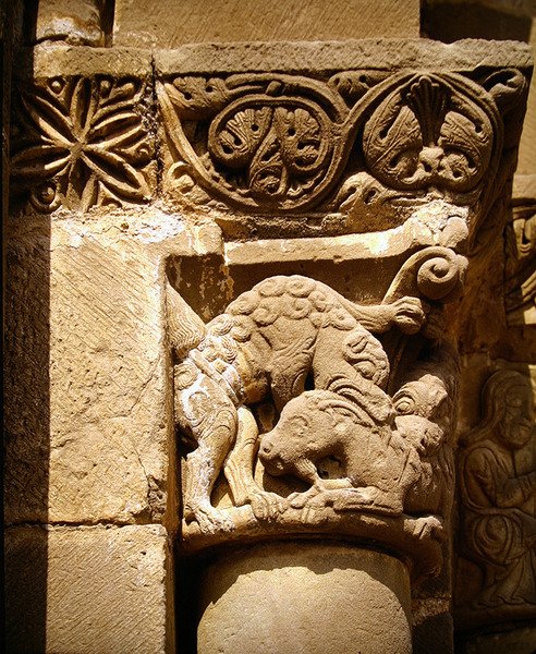 Capital Depicting a Monster Attacking a Goat by School Spanish