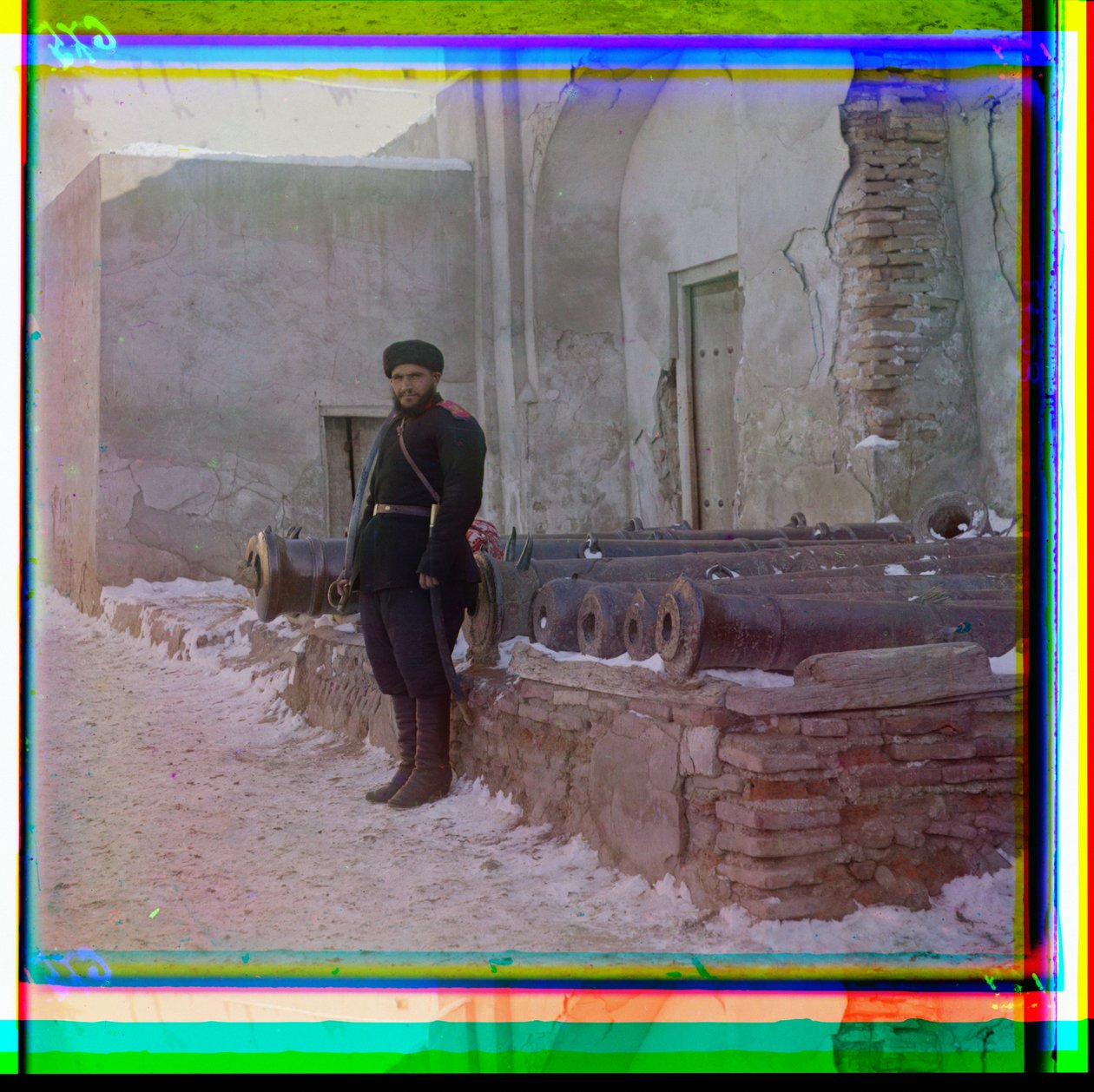 A Russian Soldier Stands Guard at a Palace Next to Old Cannons in Bukhara, 1915 by Sergey Prokudin Gorsky