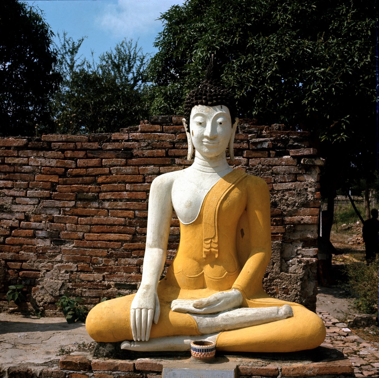A statue of Buddha outside the temple by Thai Thai