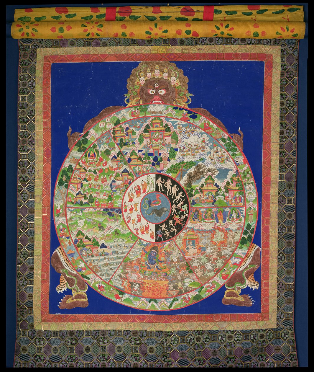 Dharmachakra Wheel of Life being turned by Yama the Lord of Death, with scenes symbolising the twelves links which cause uncontrolled rebirth around the rim, Tibetan by Tibetan School