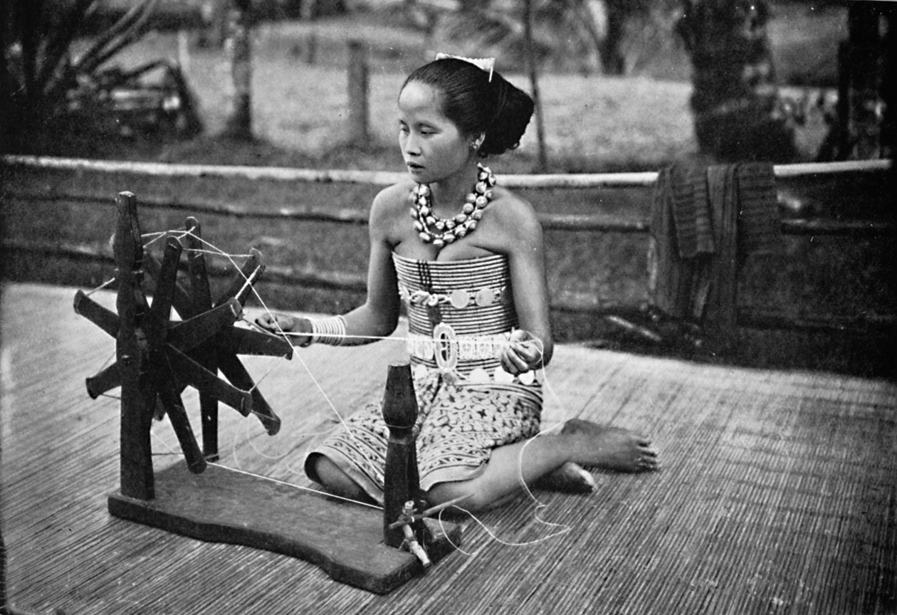 A Dayak Girl at Her Spinning Wheel by Unbekannt