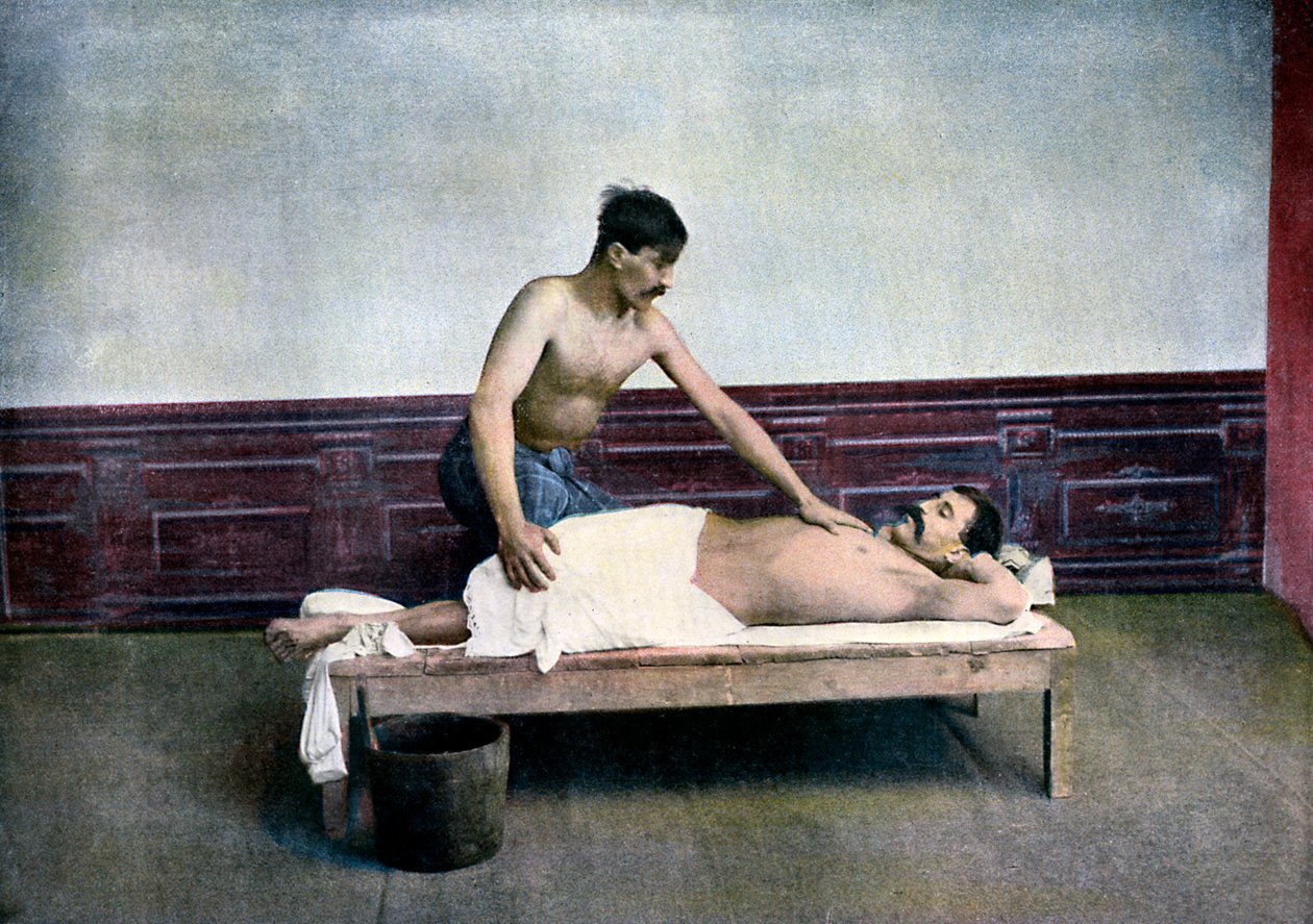 Man having a massage in bath house by Unbekannt