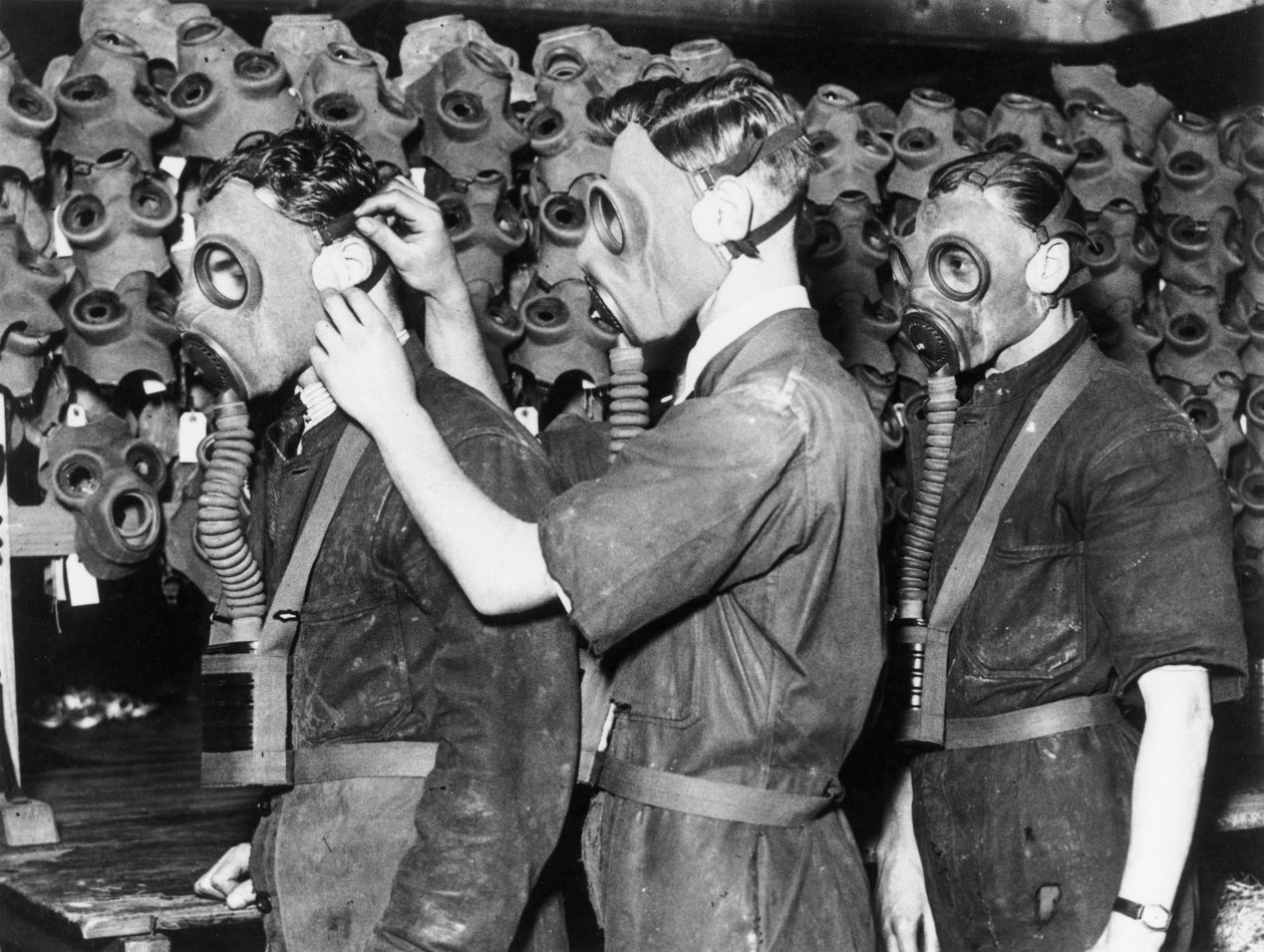 Three men wearing gas masks, c 1930s by Unbekannt