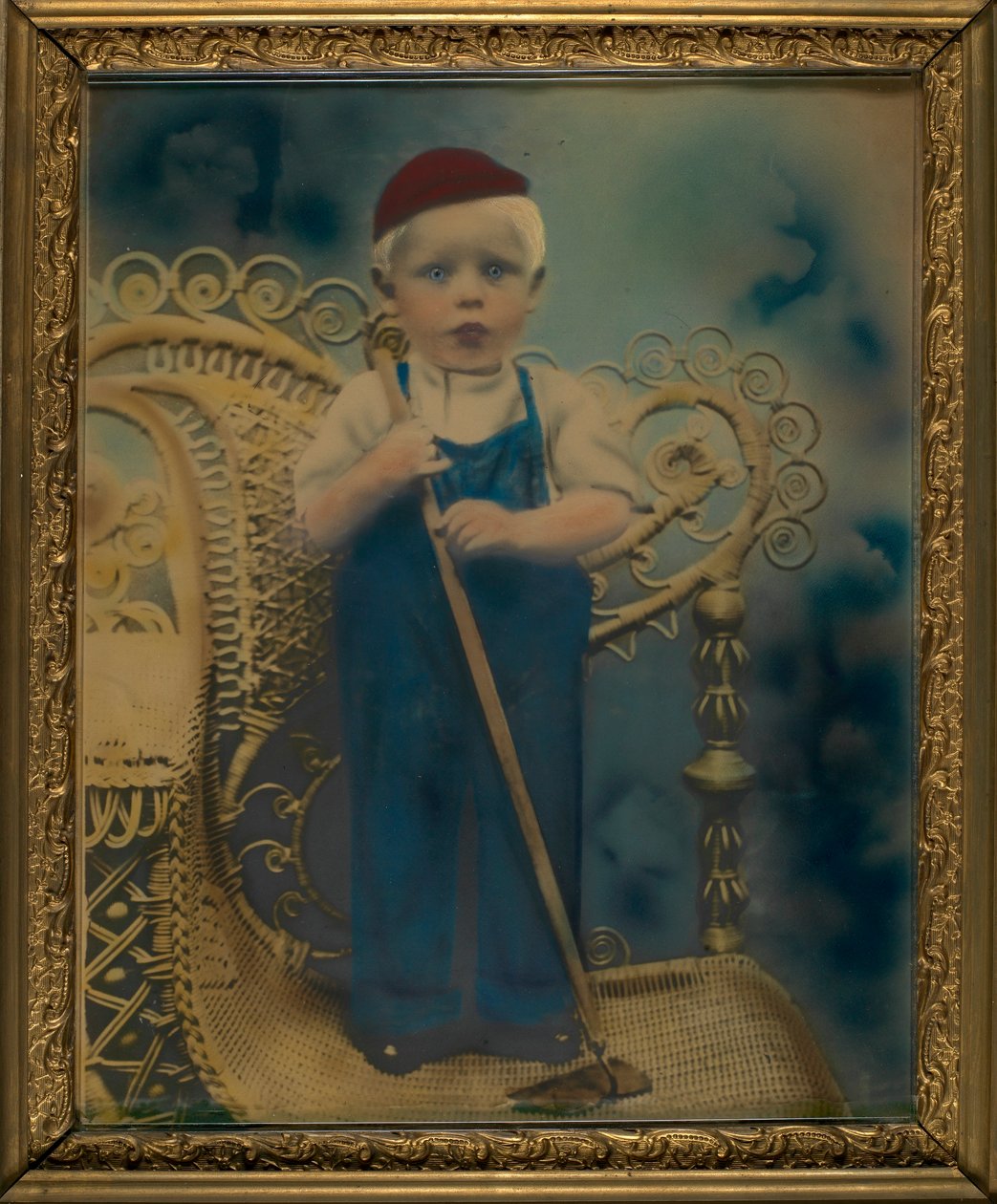 Boy Standing on Wicker Chair by Unidentified