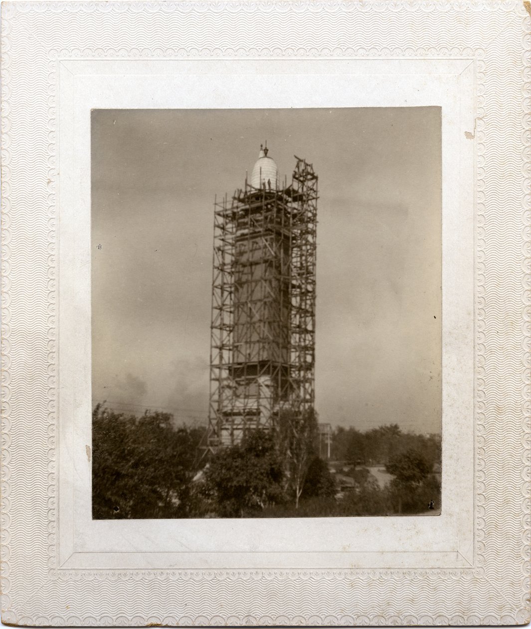 Construction of Compton Heights Water Tower Over Existing Standpipe, with Scaffolding Around Tower and Worker at Roof Level by Unknown