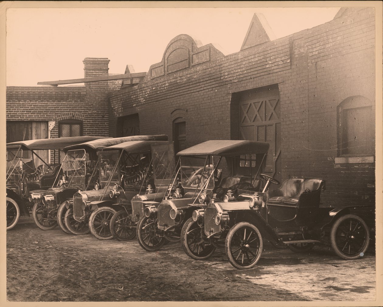 Row of Automobiles in Unidentified Lot by William G. Swekosky