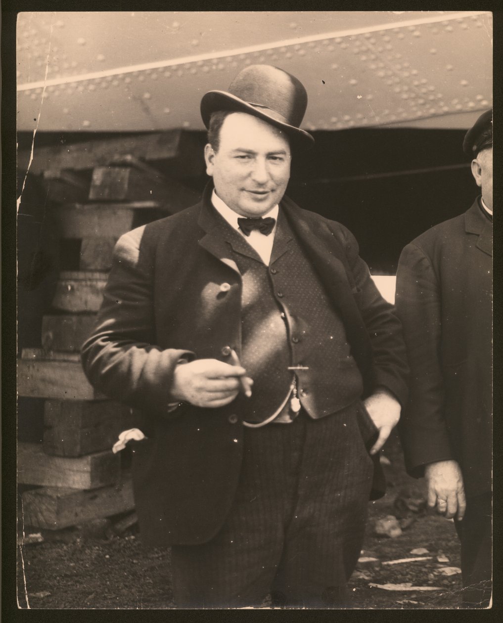 Man in a Derby Hat and Bow Tie Smoking a Cigar by William G. Swekosky