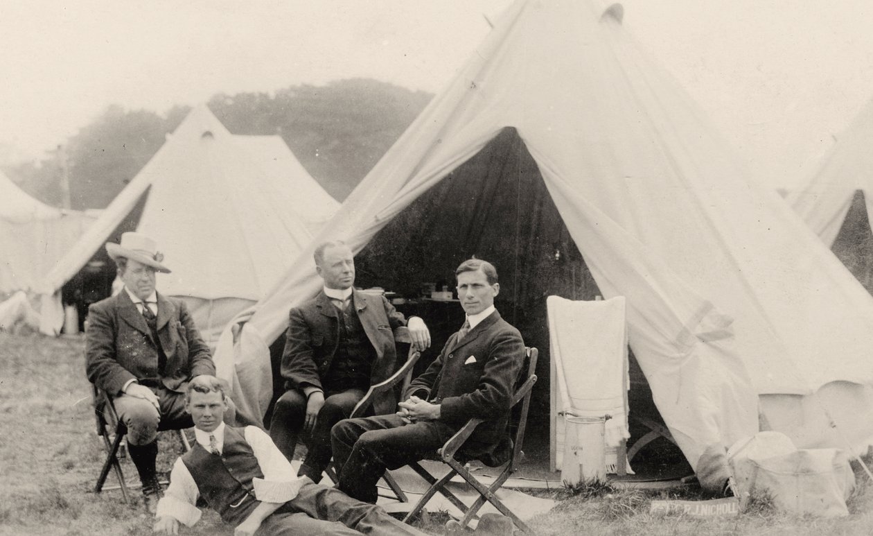 Men relaxing outside their tent by . .