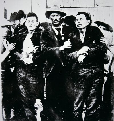 Bob and Grat Dalton with law officers by American Photographer