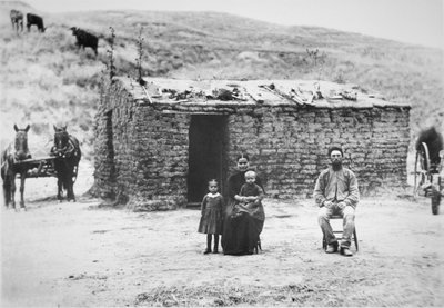Pioneer family with their sodhouse, Nebraska by American Photographer