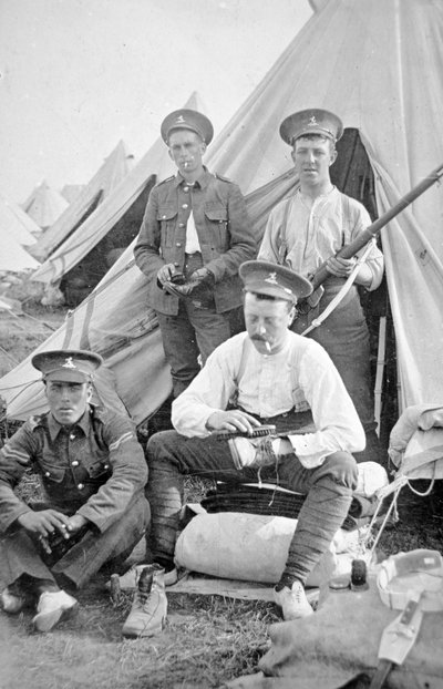 British soldiers in camp cleaning their kit by English Photographer