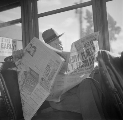 Reading war news aboard San Francisco streetcar by John Collier
