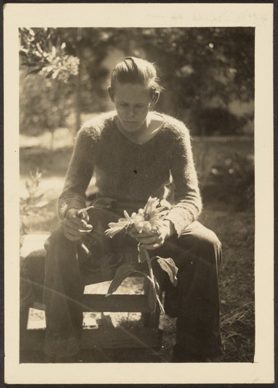 Woman Holding Sunflowers by Louis Fleckenstein