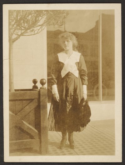 Woman Standing on Sidewalk by Louis Fleckenstein