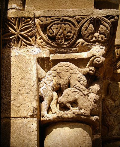 Capital Depicting a Monster Attacking a Goat by School Spanish